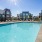 Large sparking blue pool with a large pool deck 