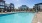 Large sparking blue pool with a large pool deck 