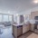 Spacious and well lit kitchen with wood flooring and stainless steel appliances