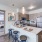 Spacious and well lit kitchen with wood flooring and stainless steel appliances