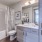 Large well lit bathroom with white accents 