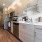 Spacious and well lit kitchen with wood flooring and stainless steel appliances
